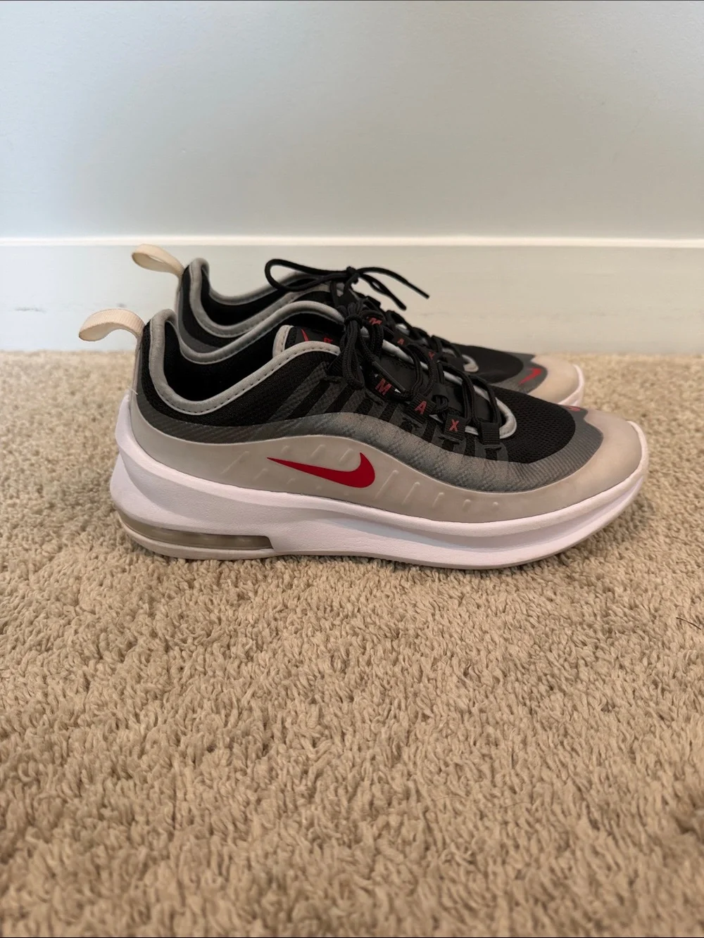 Nike Air Max Axis sneakers in a black and white colorway with red accents